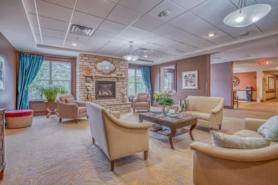 Bright common area with seating and a fireplace