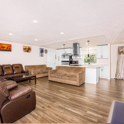Bright common area with couches and kitchen