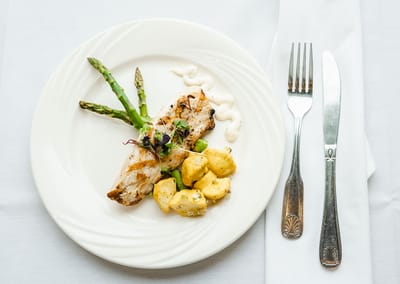 A plated meal featuring fish and asparagus