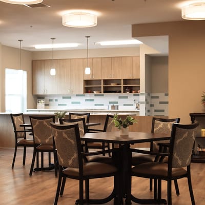 Common area with dining tables and kitchen