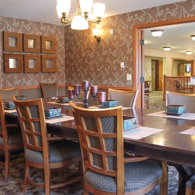 Dining area with a large wooden table and chairs