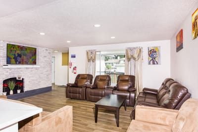 Common area with seating and television in a senior living facility