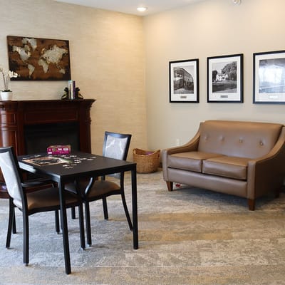 Lounge area with a table and artwork on the wall