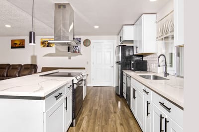 Modern kitchen with white cabinets and stainless steel appliances