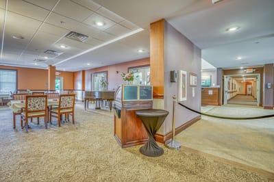 Bright common area with seating and piano