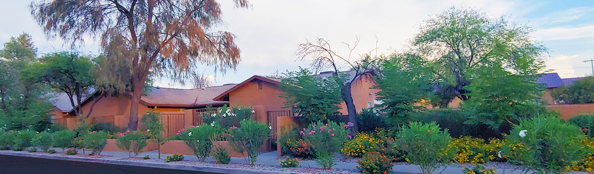 Exterior view of Groves Assisted Living with landscaped garden.