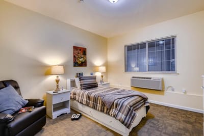 Cozy resident room with bed and lighting