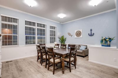 Dining area with a table and seating for residents