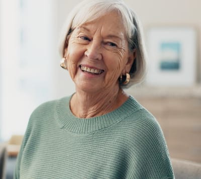Smiling elderly woman in a cozy indoor setting