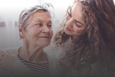 A touching moment between a caregiver and a resident
