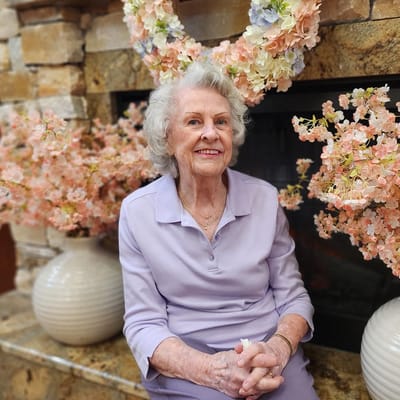Resident smiling in a decorated common area