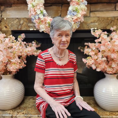 Resident sitting in a beautifully decorated common area.