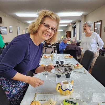 A staff member serving snacks at a social gathering
