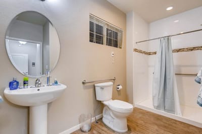 Clean bathroom with shower and sink amenities