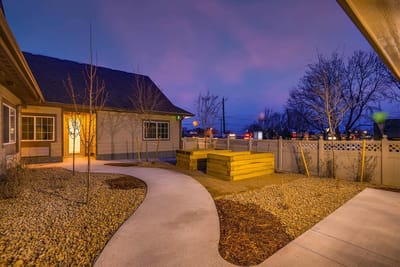 Well-lit garden path leading to the facility