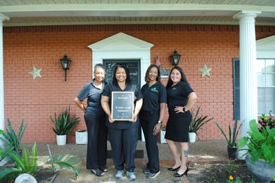 Staff welcoming at the entrance of Cozy Living Community