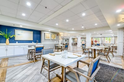 Bright dining room with tables set for residents
