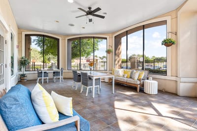 Bright sunroom with comfortable seating and large windows