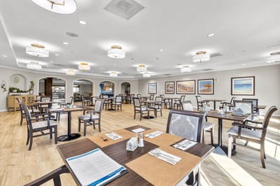 Bright dining room with tables set for meals