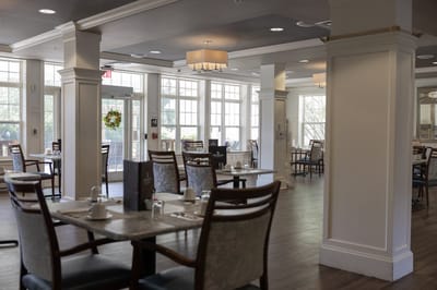 Brightly lit dining area with tables and chairs