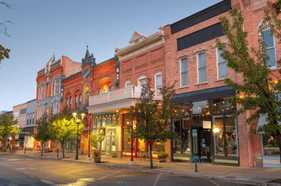 A historic street with brick buildings and trees