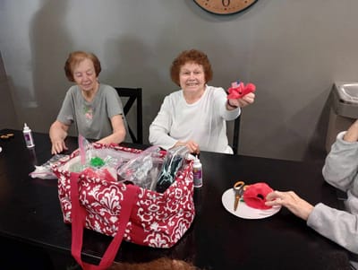 Residents engaged in a crafting activity at the facility