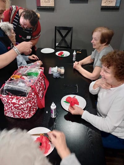 Residents engaged in a crafting activity at a table