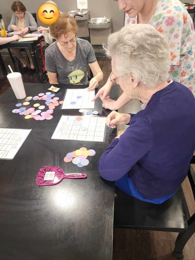 Residents playing bingo in an activity room