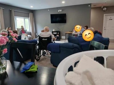 Residents engaging in a common area with smiling faces