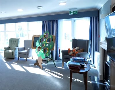 Bright common area with chairs and activity tree