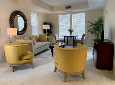 Cozy sitting area with yellow chairs and a small dining table