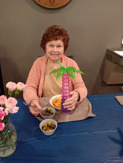 Resident enjoying a meal with decorative palm cup