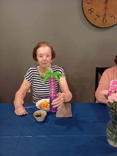 Resident enjoying a meal with decorative drink