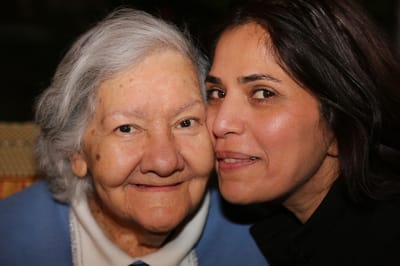 Two women smiling closely together