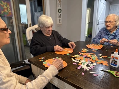 Residents engaging in a craft activity at a table