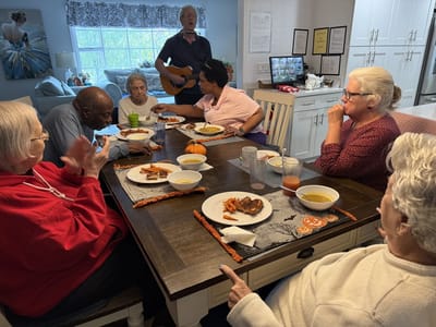 Residents enjoying a meal and music together