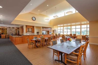 Bright and spacious common area with dining tables