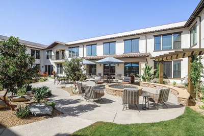 Outdoor patio area with seating and landscaping