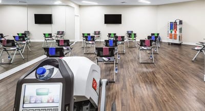 Interior fitness area with exercise equipment and seating