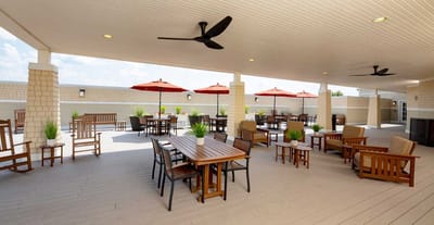 Outdoor seating area with umbrellas and greenery