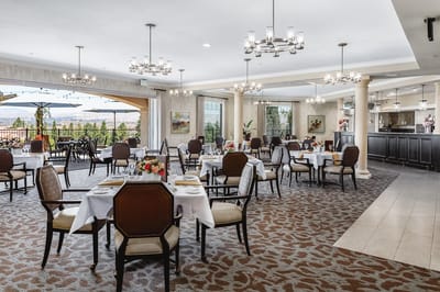 Elegant dining room with tables set for residents