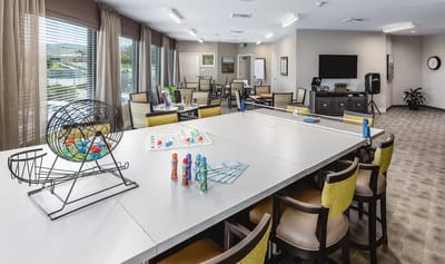 Bright activity room with bingo setup and seating