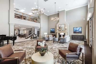 Bright common area with seating and chandeliers