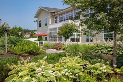 Exterior view of a facility with gardens and seating