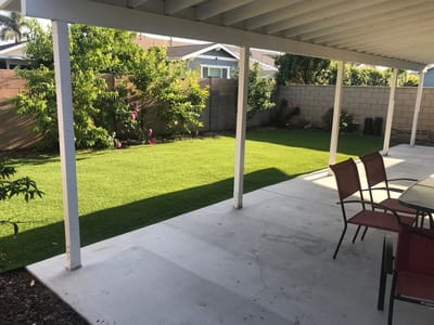 Outdoor patio area with seating and green lawn