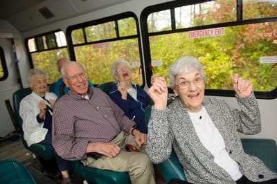 Residents enjoying a fun outing in a bus