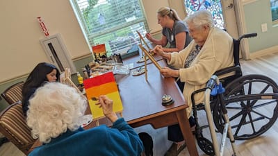 Residents participating in a painting activity