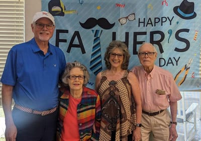 Residents and staff celebrating Father's Day in a common area