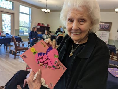 Resident celebrating Valentine's Day with a handmade card