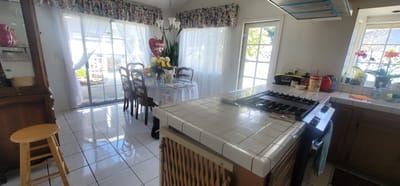 Bright kitchen and dining area with floral curtains